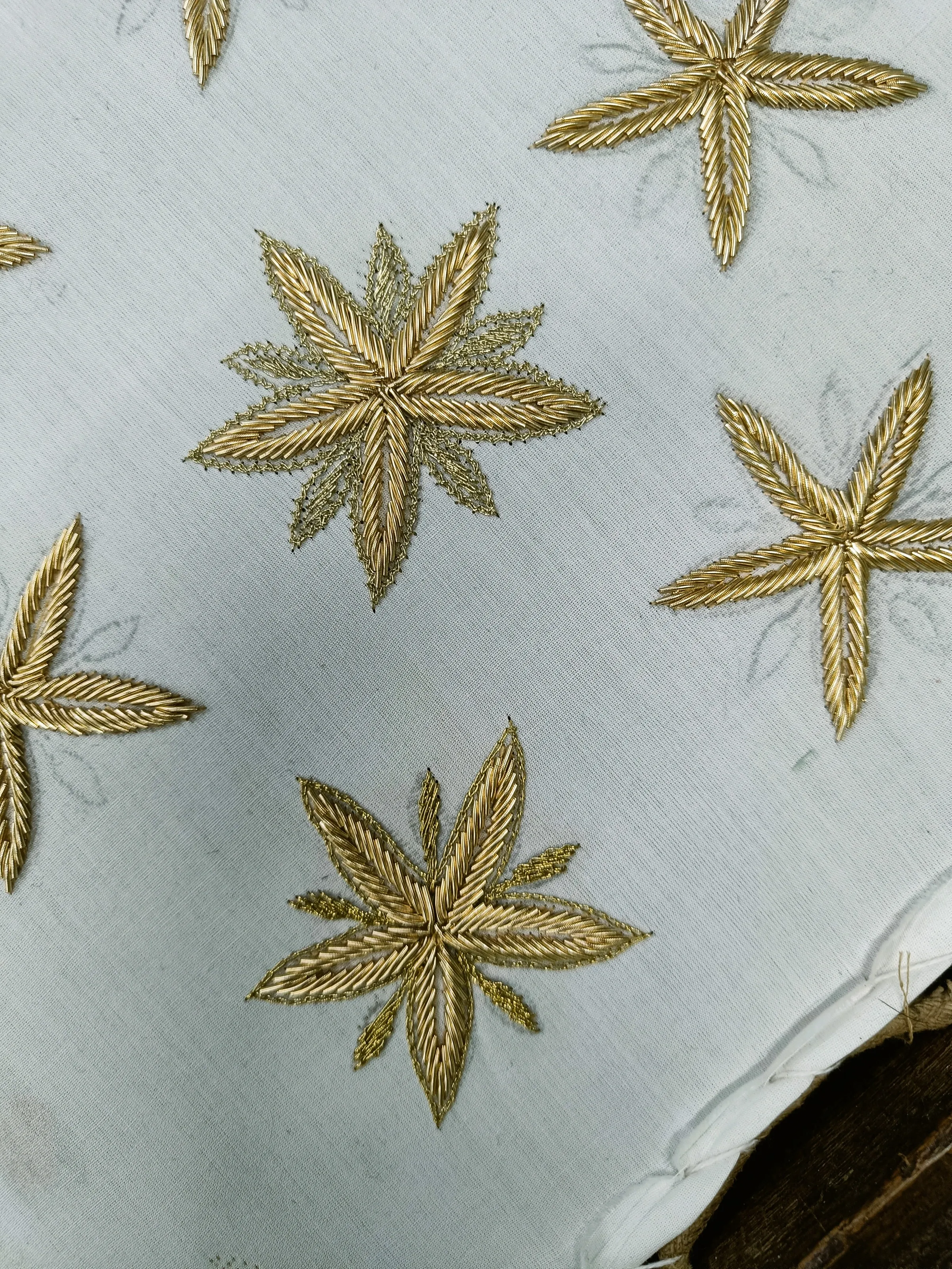 Detail of the gold Zardozi coffee-flower embroidery in progress at Starbucks Taj Eatery, Agra